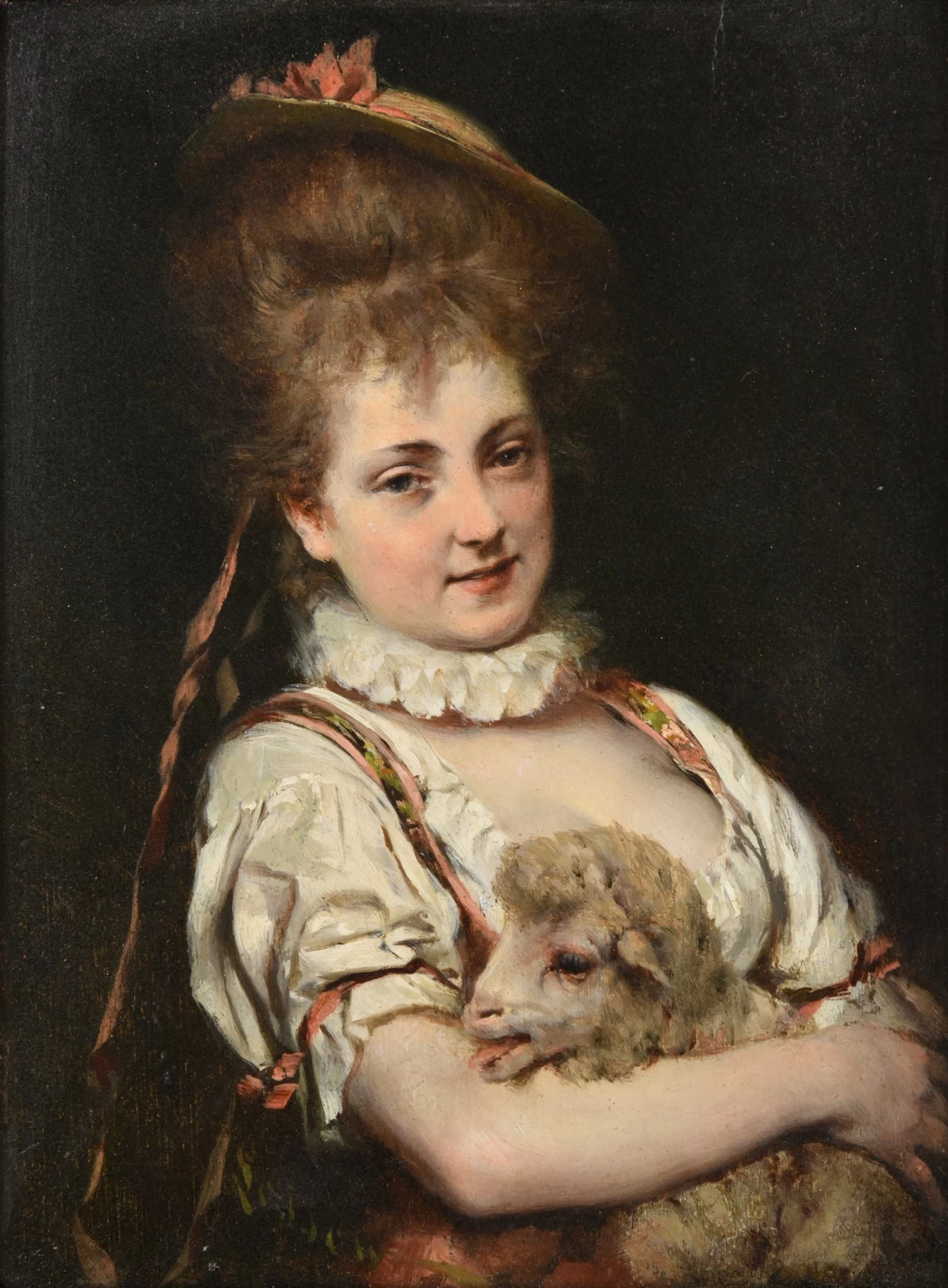 Giovane donna in abiti fantasiosi che culla un agnello